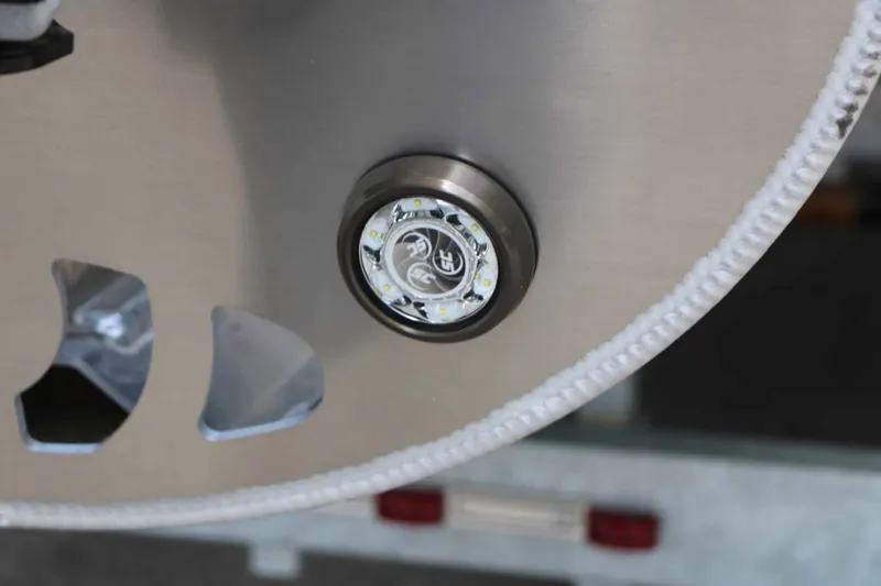 Slide: The Image of Close-up of a round LED light on a boat, surrounded by metal. - 22