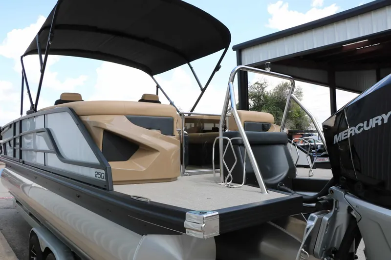 Slide: The Image of The image shows a modern pontoon boat with a spacious deck and a Mercury outboard motor. - 23