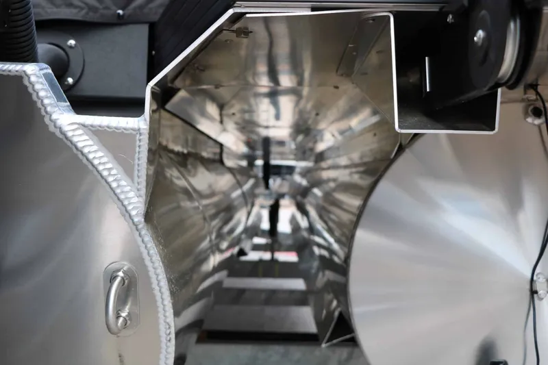 Slide: The Image of Close-up of a shiny metal tube with intricate welds and mechanical components. - 21