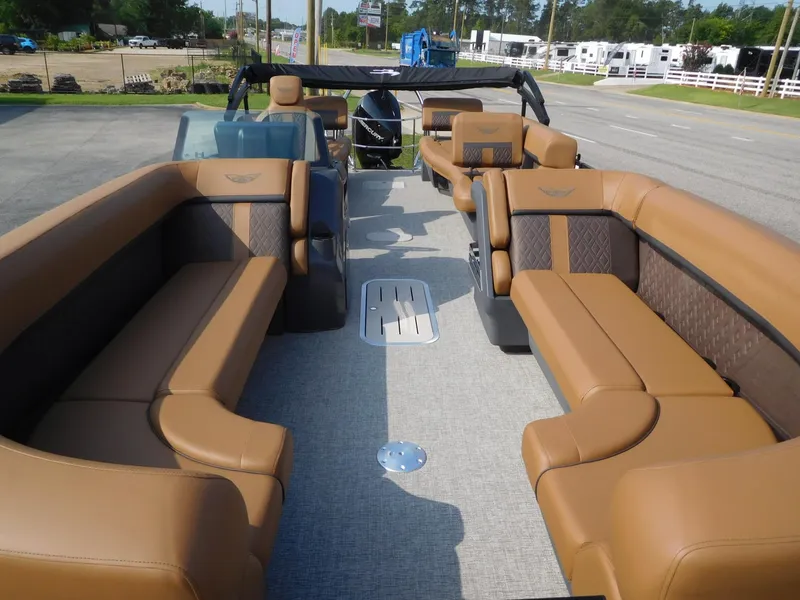 Slide: The Image of The image shows the interior of a Bennington 24 MSL pontoon boat with brown leather seating. - 8