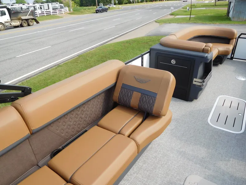 Slide: The Image of The image shows the interior of a 2026 Bennington 24 MSL with luxurious brown seating. - 14