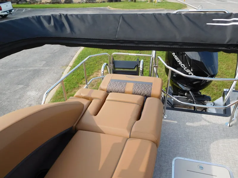 Slide: The Image of The image shows the deck of a Bennington 24 MSL with beige upholstery and a Mercury outboard motor. - 19