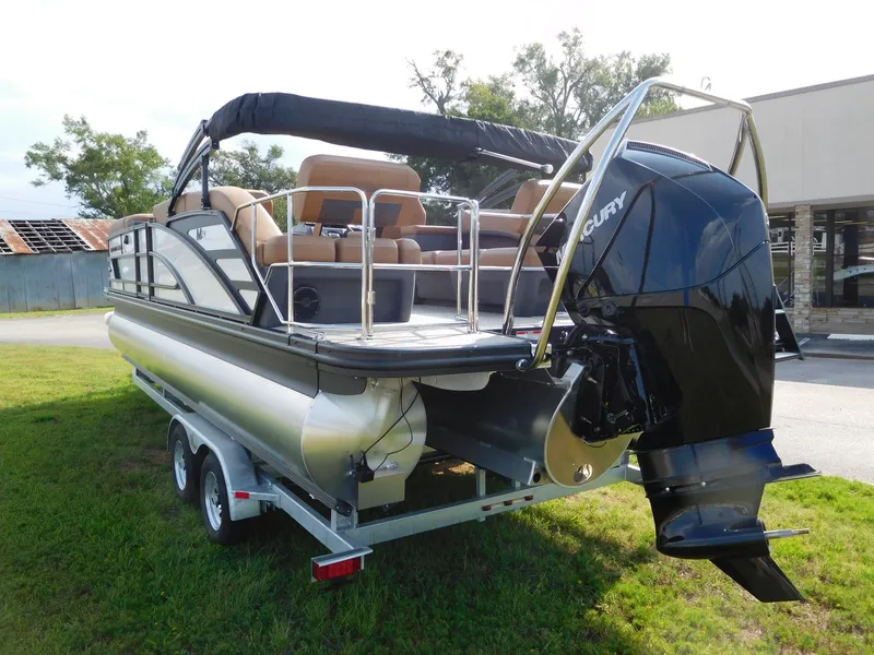 Slide: The Image of A 2026 Bennington 24 MSL pontoon boat on a trailer. It features a Mercury outboard motor. - 3