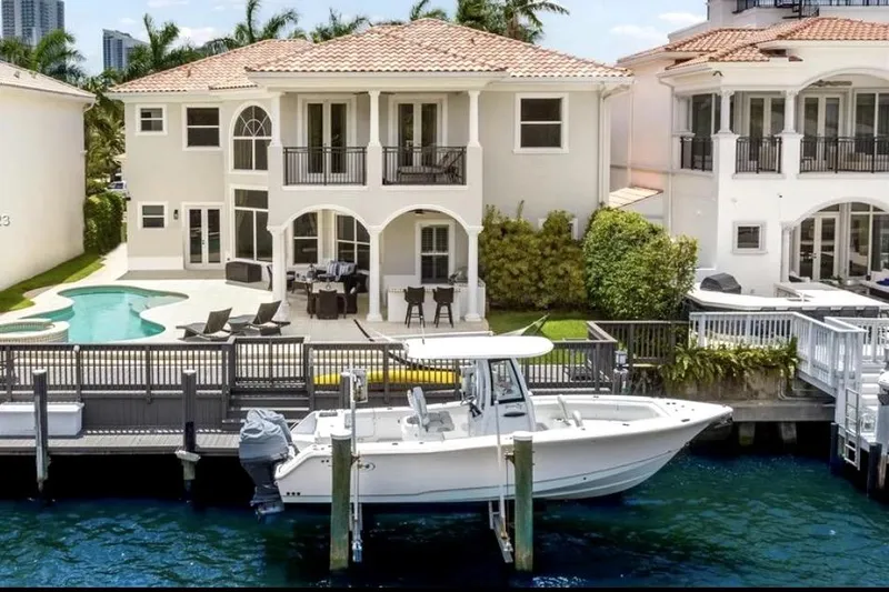 The Image of 2020 Sea Hunt Gamefish 27 docked by luxurious waterfront home with pool. - 0