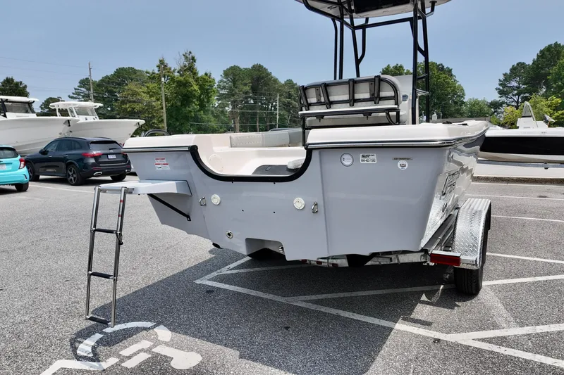 Slide: The Image of 2027 Carolina Skiff 21 Ultra Elite boat on trailer in parking lot. - 16