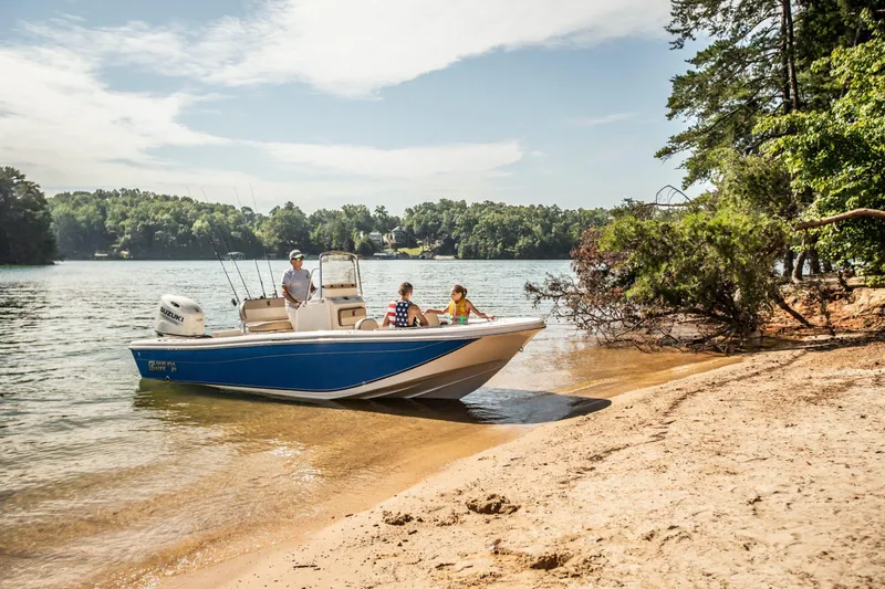 The Image of 2027 Carolina Skiff 21 Ultra Elite boat on sandy shore with people enjoying the lake. - 1
