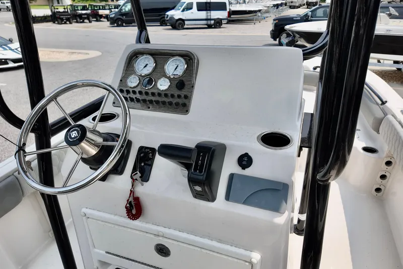 Slide: The Image of 2027 Carolina Skiff 21 Ultra Elite boat dashboard with steering wheel and gauges. - 11