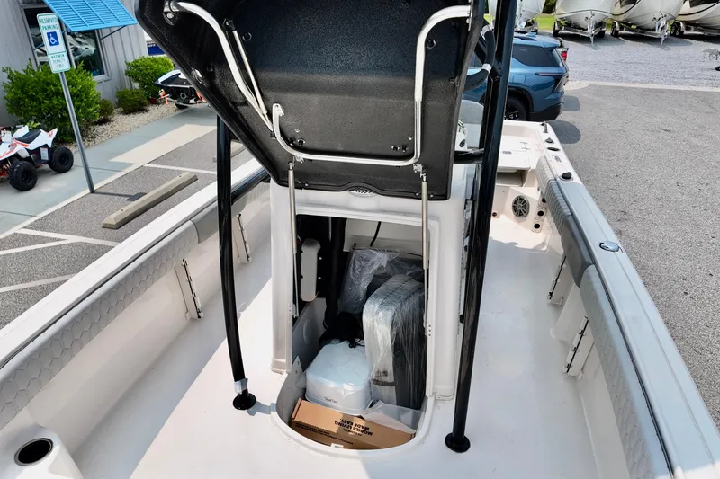 Slide: The Image of 2027 Carolina Skiff 21 Ultra Elite boat interior with storage compartment and seating. - 9