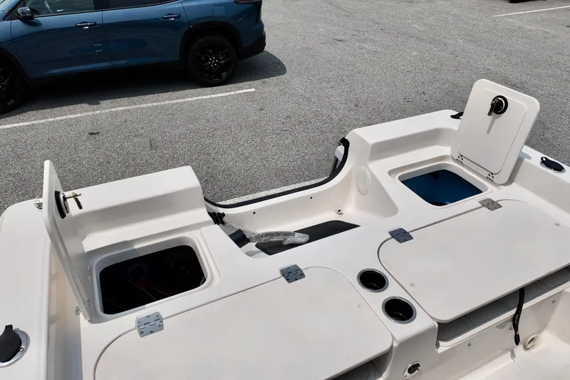 Slide: The Image of 2027 Carolina Skiff 21 Ultra Elite boat interior with storage compartments and cup holders. - 14