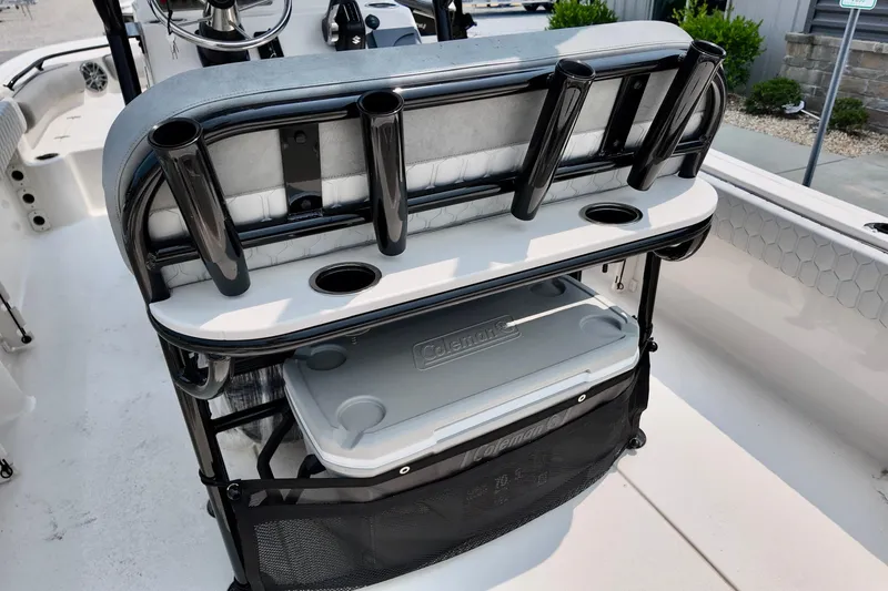 Slide: The Image of 2027 Carolina Skiff 21 Ultra Elite boat interior with rod holders and cooler storage. - 2