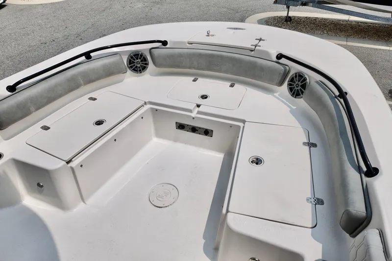 Slide: The Image of 2027 Carolina Skiff 21 Ultra Elite boat interior with cushioned seating and storage compartments. - 7