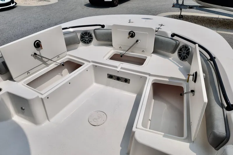 Slide: The Image of 2027 Carolina Skiff 21 Ultra Elite boat interior with open storage compartments and speakers. - 6