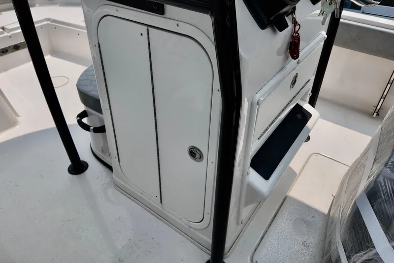 Slide: The Image of 2027 Carolina Skiff 21 Ultra Elite boat console with storage compartments. - 5