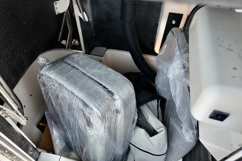 Slide: The Image of Storage compartment of 2027 Carolina Skiff 21 Ultra Elite with wrapped luggage and bags. - 3