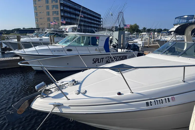Slide: The Image of 2003 Sea Ray Sundancer 280 docked at marina, surrounded by other boats. - 3