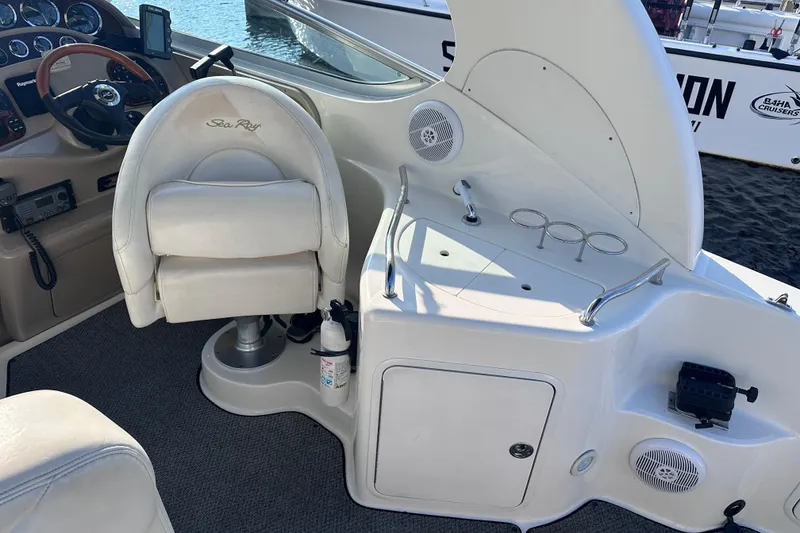 Slide: The Image of 2003 Sea Ray Sundancer 280 helm with steering wheel, captain's chair, and control panel. - 12