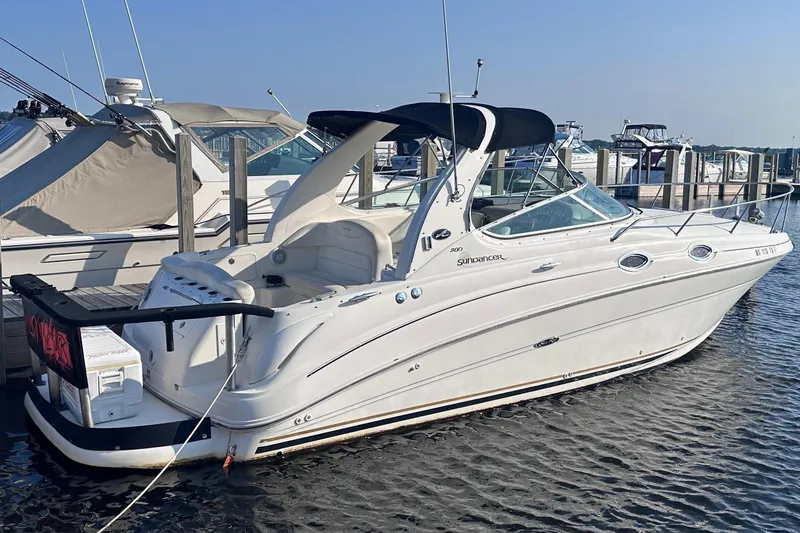 The Image of A white 2003 Sea Ray Sundancer 280 docked, featuring a black canopy. - 0