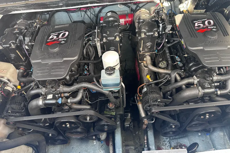 Slide: The Image of Two powerful engines in the engine room of a 2003 Sea Ray Sundancer 280. - 26