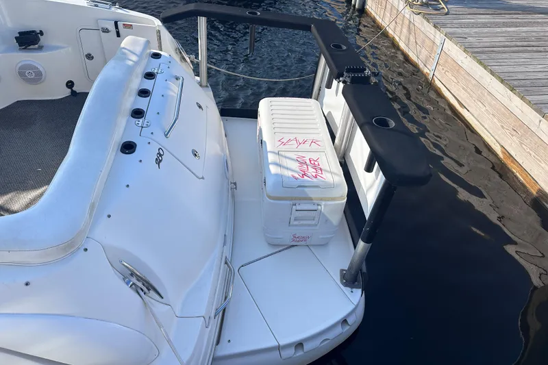 Slide: The Image of 2003 Sea Ray Sundancer 280 boat with cooler on swim platform, docked by wooden pier. - 6