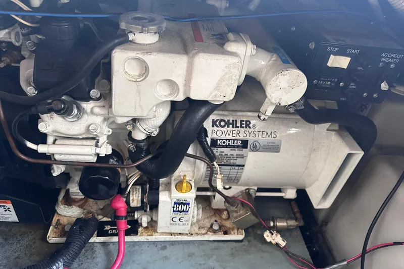 Slide: The Image of A Kohler generator system in a boat engine compartment, surrounded by wires and switches. - 27