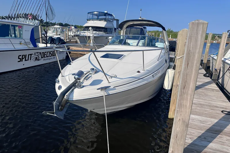 Slide: The Image of 2003 Sea Ray Sundancer 280 docked at marina, surrounded by other boats. - 2