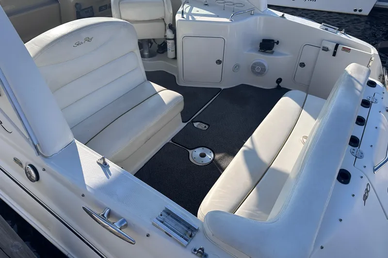 Slide: The Image of 2003 Sea Ray Sundancer 280 boat interior with white seating and carpeted floor. - 17