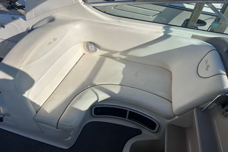 Slide: The Image of 2003 Sea Ray Sundancer 280 interior seating with white upholstery and speaker. - 18