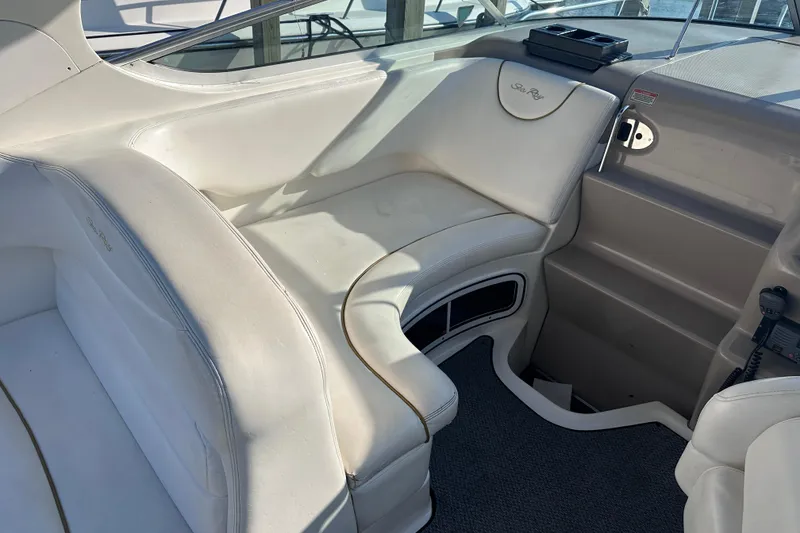 Slide: The Image of Interior of 2003 Sea Ray Sundancer 280 boat with white seating and dashboard. - 19