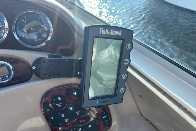 Slide: The Image of FishHawk electronics on 2003 Sea Ray Sundancer 280 dashboard with water view. - 14