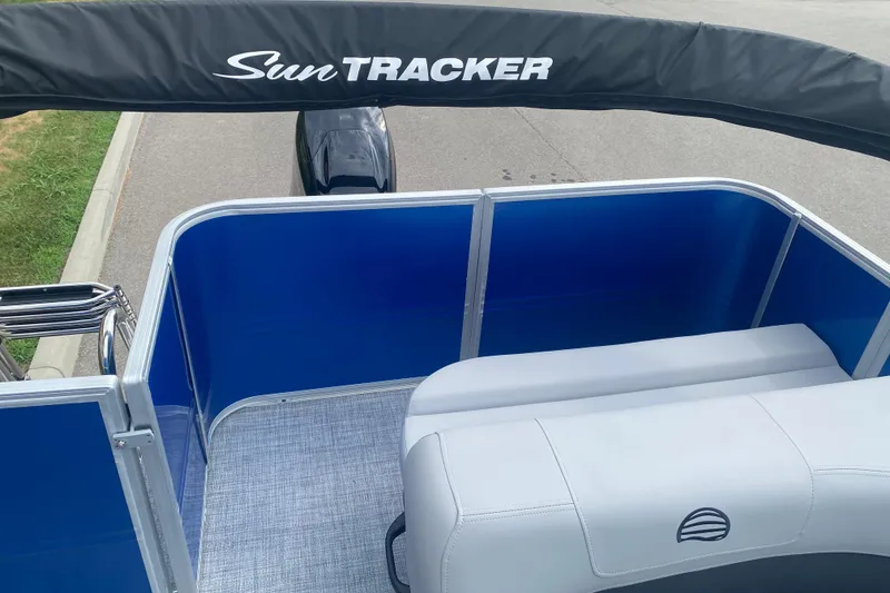 Slide: The Image of 2026 Sun Tracker Party Barge 18 DLX pontoon boat interior with blue panels and seating. - 10