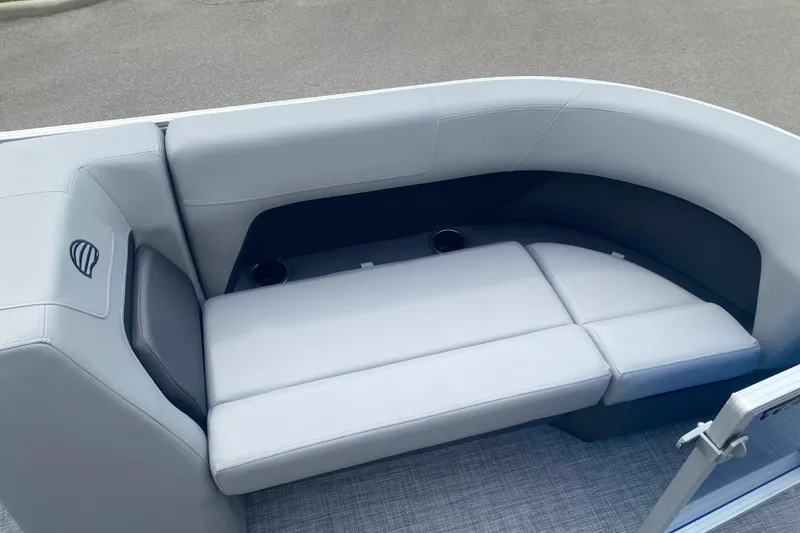 Slide: The Image of 2026 Sun Tracker Party Barge 18 DLX interior with plush seating and cup holders. - 7
