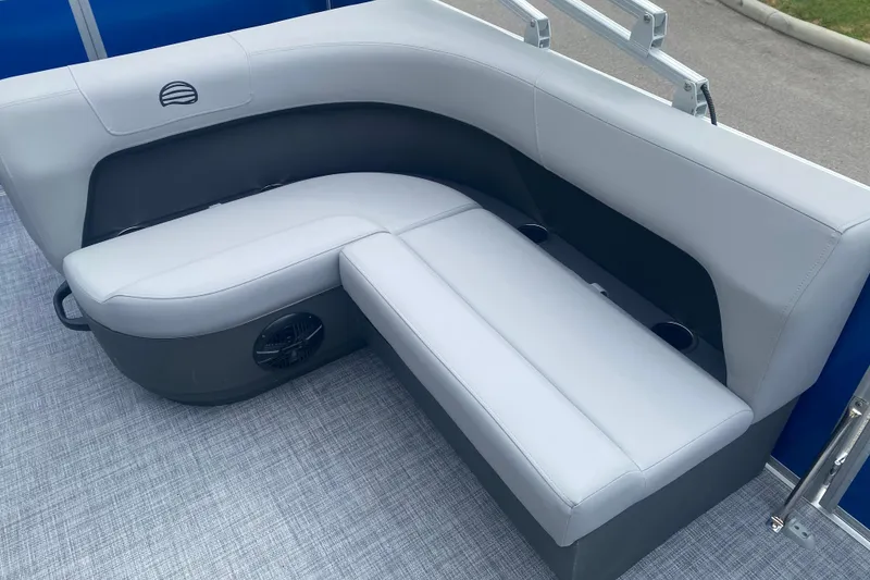Slide: The Image of 2026 Sun Tracker Party Barge 18 DLX interior seating with cup holders and speaker. - 5