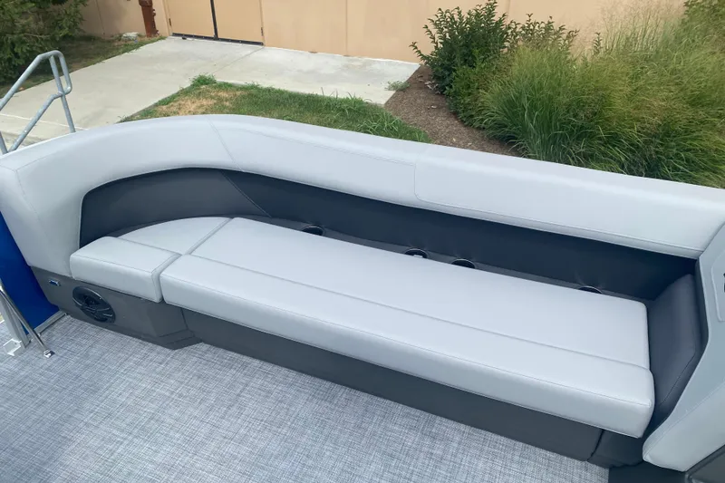Slide: The Image of 2026 Sun Tracker Party Barge 18 DLX pontoon boat seating area with gray upholstery. - 6