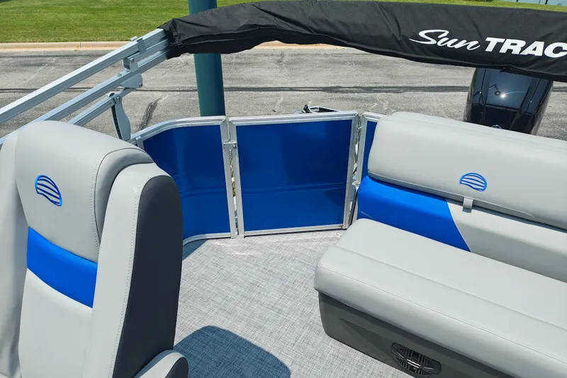 Slide: The Image of 2026 Sun Tracker Party Barge 20 DLX interior with blue and gray seating. - 14