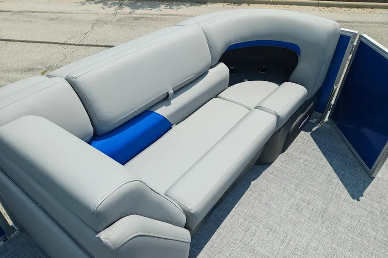 Slide: The Image of 2026 Sun Tracker Party Barge 20 DLX interior with gray and blue seating. - 26