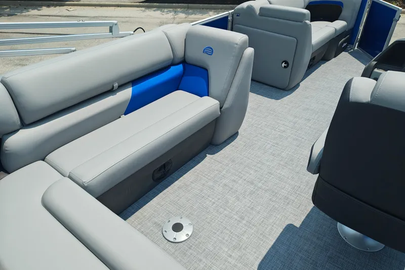 Slide: The Image of 2026 Sun Tracker Party Barge 20 DLX interior with gray and blue seating. - 22