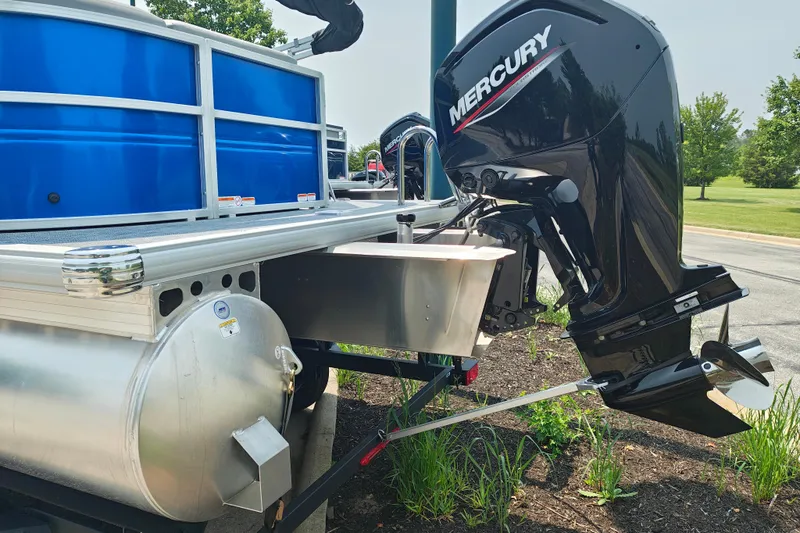 Slide: The Image of 2026 Sun Tracker Party Barge 20 DLX with Mercury outboard motor, parked outdoors. - 3