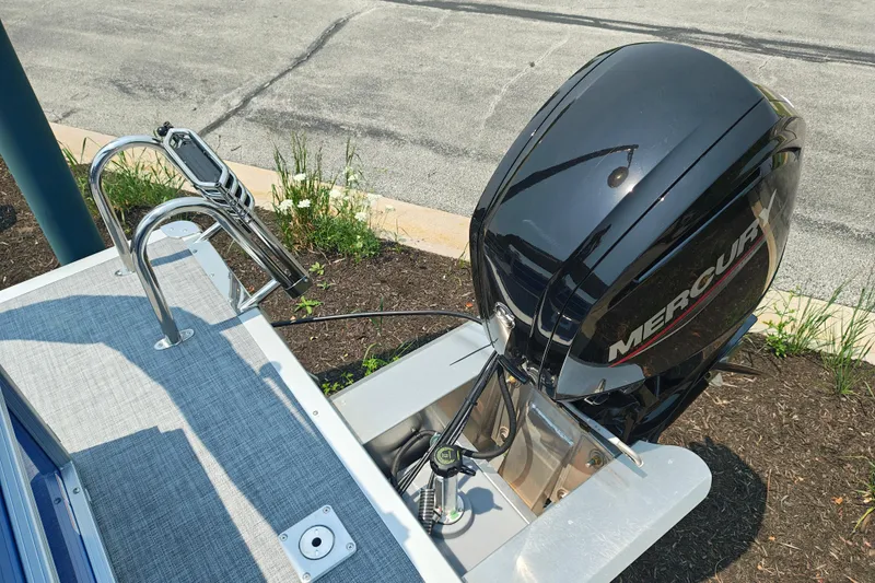 Slide: The Image of 2026 Sun Tracker Party Barge 20 DLX with Mercury outboard motor, docked outdoors. - 19