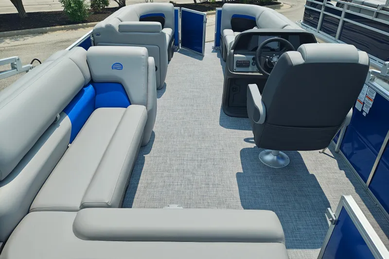 Slide: The Image of 2026 Sun Tracker Party Barge 20 DLX interior with gray seating and modern helm. - 21