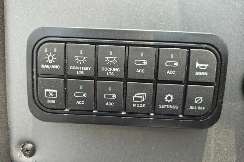 Slide: The Image of Control panel of a 2026 Sun Tracker Party Barge 20 DLX with various switches and buttons. - 17