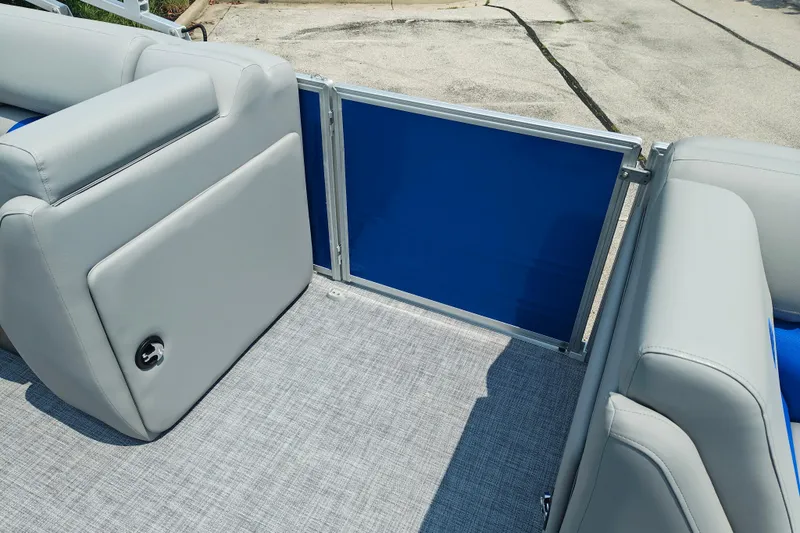 Slide: The Image of 2026 Sun Tracker Party Barge 20 DLX interior with gray seating and blue panel. - 9