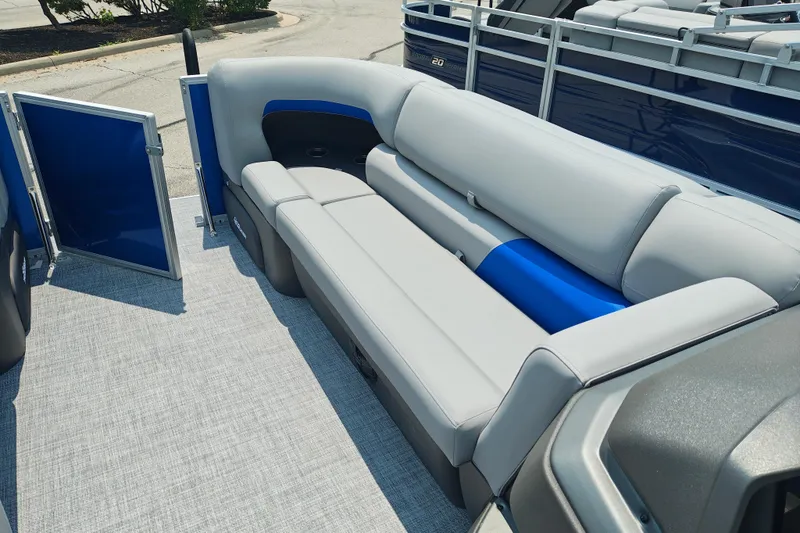 Slide: The Image of 2026 Sun Tracker Party Barge 20 DLX interior with gray and blue seating. - 24