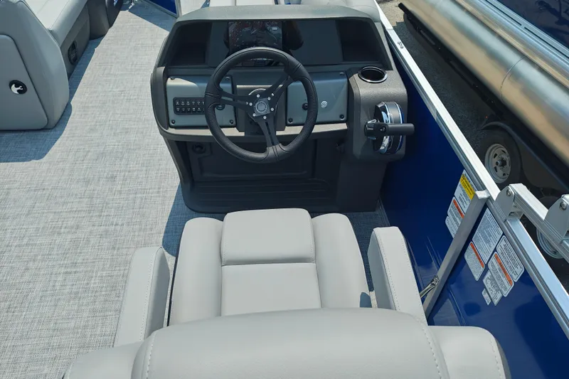 Slide: The Image of 2026 Sun Tracker Party Barge 20 DLX helm with steering wheel and controls. - 15