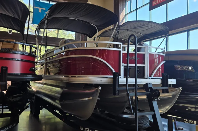 The Image of 2026 Sun Tracker Sportfish 24 XP3 pontoon boat displayed indoors. - 0