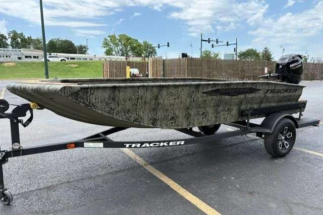 Slide: The Image of 2026 Tracker Grizzly 1650 T Prairie Wings Edition boat on trailer in parking lot. - 6