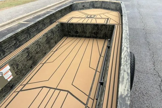Slide: The Image of 2026 Tracker Grizzly 1650 T Prairie Wings Edition boat interior with camouflage design. - 20