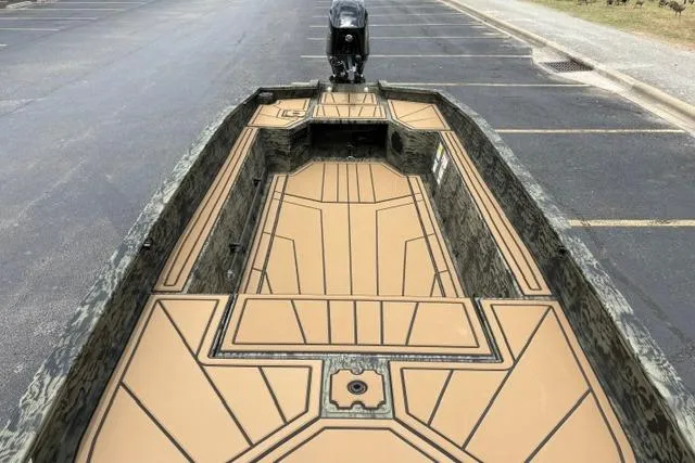 Slide: The Image of 2026 Tracker Grizzly 1650 T Prairie Wings Edition boat with camo design in parking lot. - 17