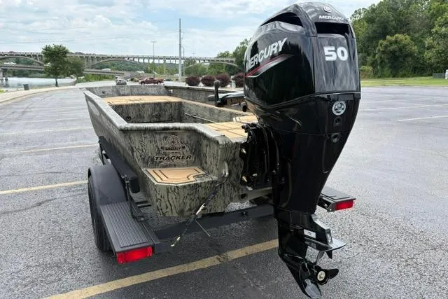 Slide: The Image of 2026 Tracker Grizzly 1650 T Prairie Wings Edition boat with Mercury 50 engine in parking lot. - 10