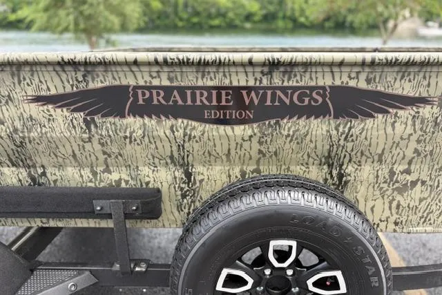 Slide: The Image of 2026 Tracker Grizzly 1650 T Prairie Wings Edition with camouflage design and Load Star tire. - 13