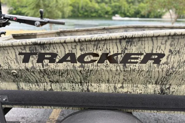 Slide: The Image of 2026 Tracker Grizzly 1650 T Prairie Wings Edition boat with camouflage design near water. - 12